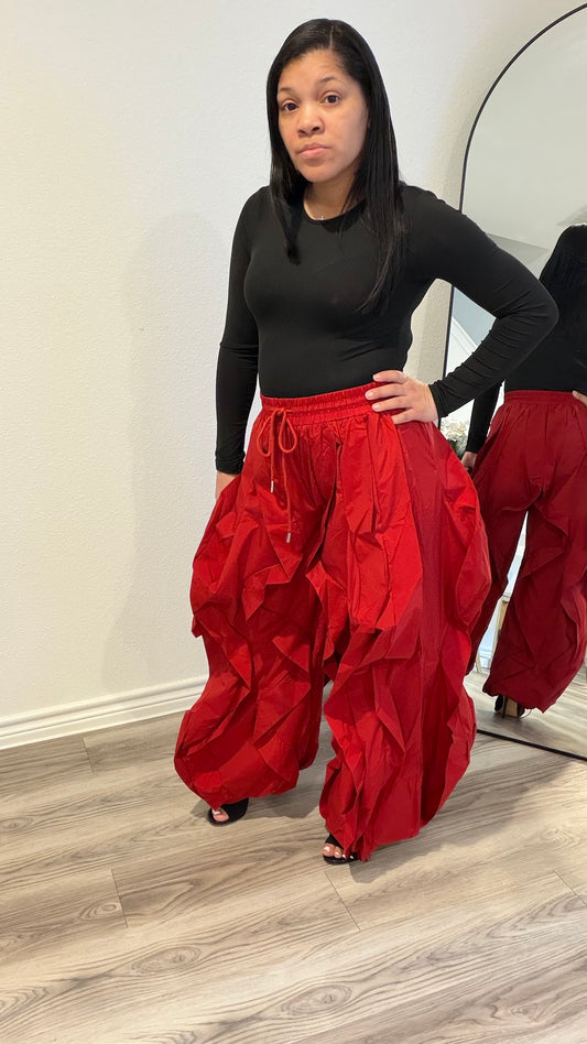 Woman wearing statement pants with layered fabric and dramatic volume.