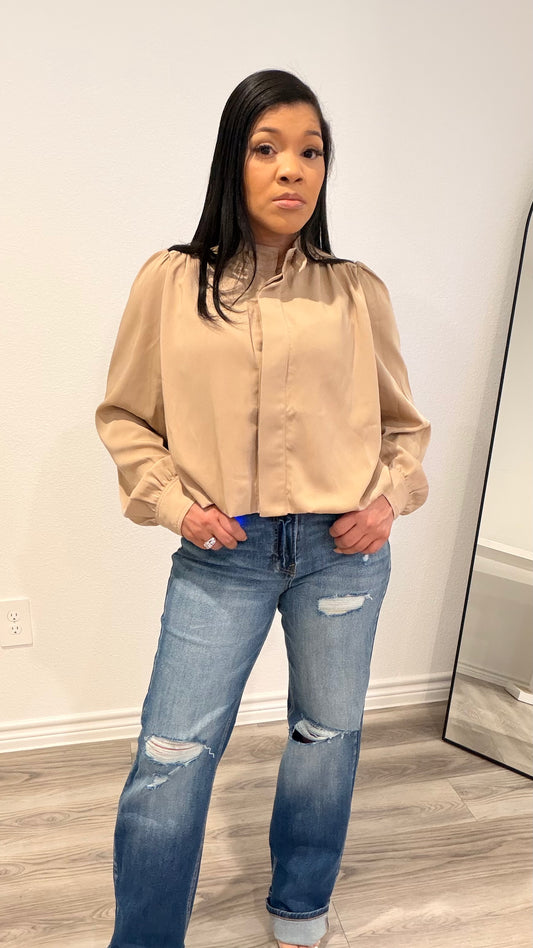 Woman wearing a woven blouse with a relaxed fit and softly shaped hem.