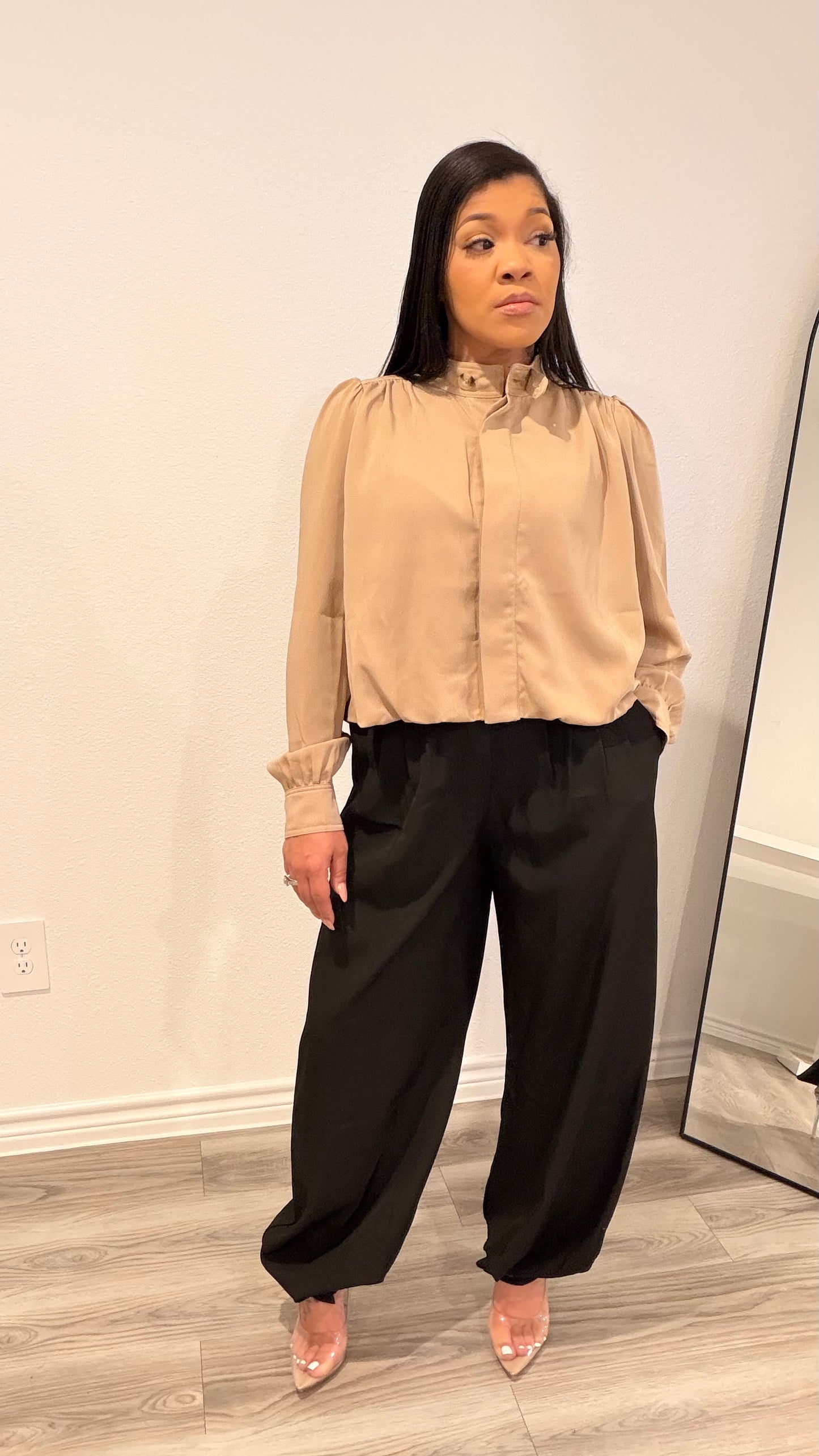 Woman wearing a woven blouse with a relaxed fit and softly shaped hem.