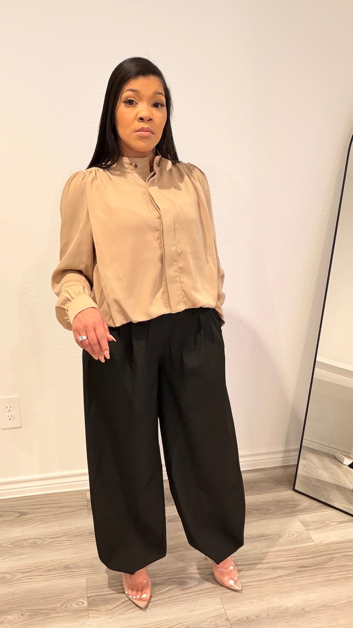 Woman wearing barrel-leg trousers with a relaxed, sculpted silhouette.