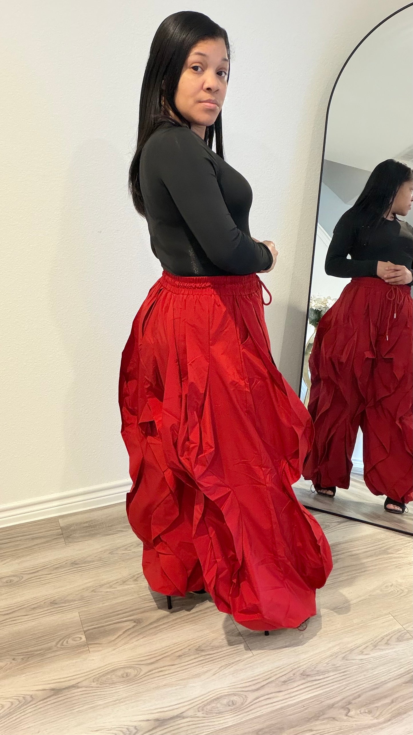 Woman wearing statement pants with layered fabric and dramatic volume.