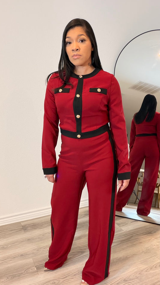 Woman wearing a tailored two-piece set with contrast trim and wide-leg pants.