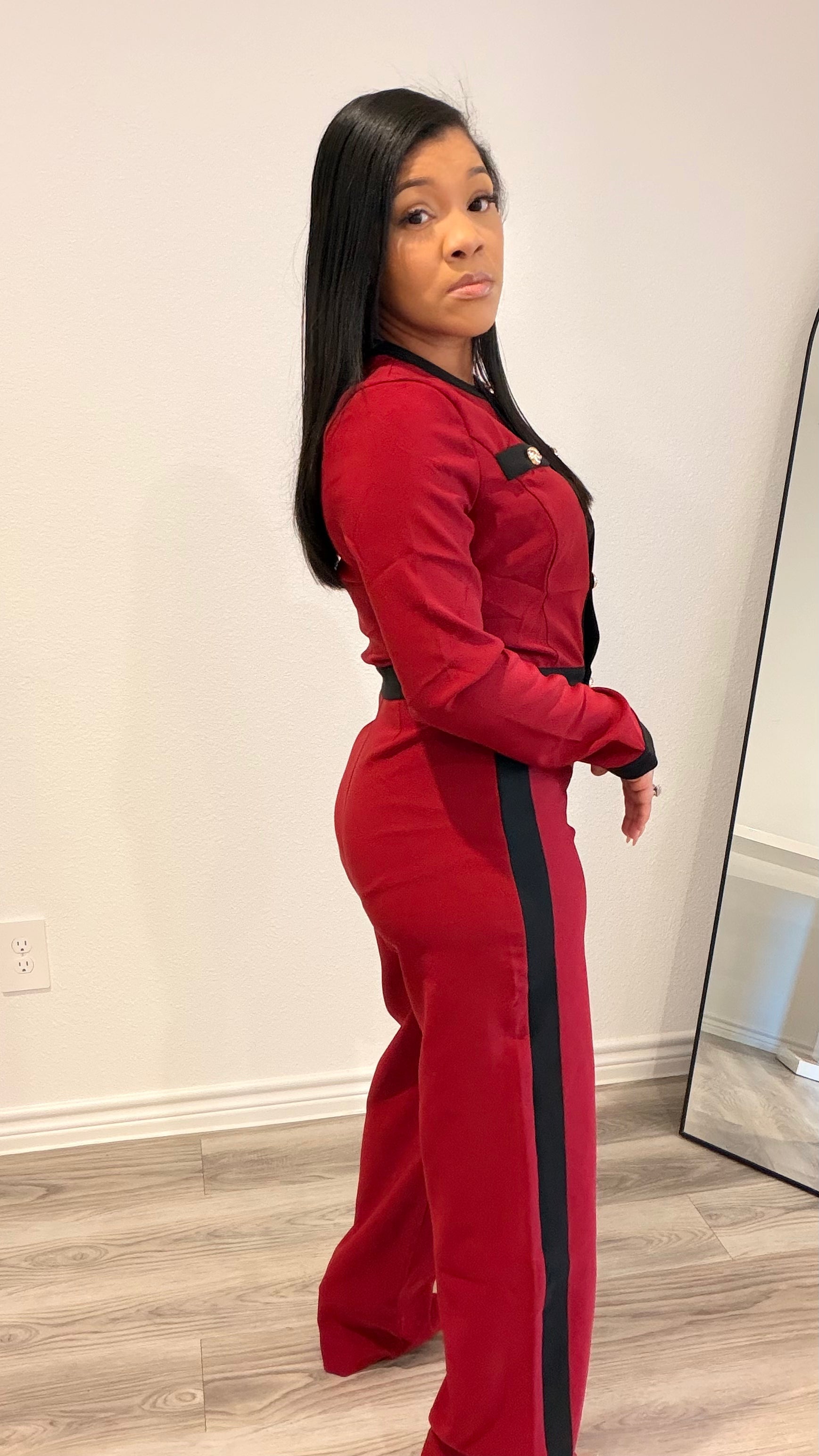Woman wearing a tailored two-piece set with contrast trim and wide-leg pants.