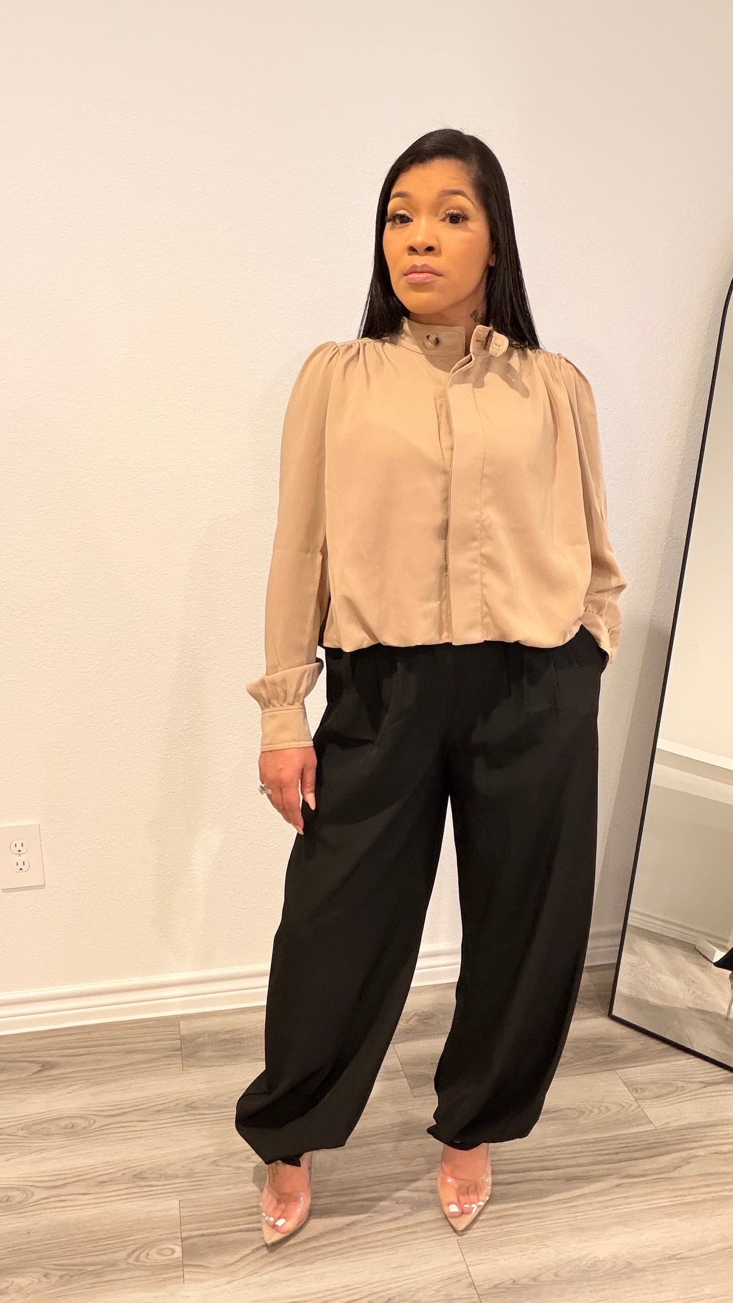 Woman wearing barrel-leg trousers with a relaxed, sculpted silhouette.