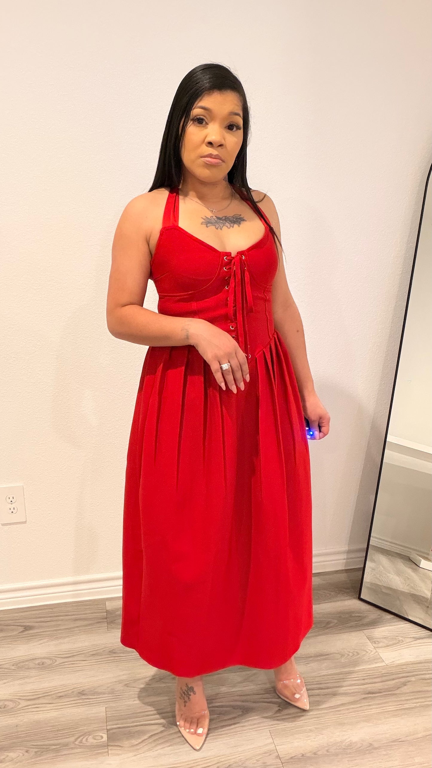 Woman wearing a structured corset dress with a fitted bodice and flowing skirt