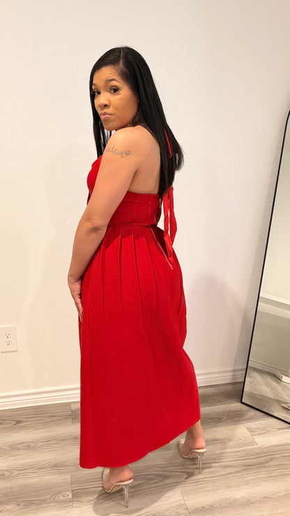 Woman wearing a structured corset dress with a fitted bodice and flowing skirt