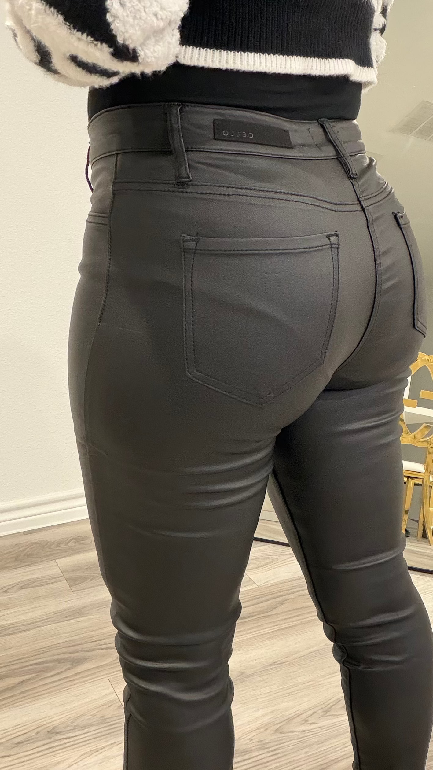 Woman wearing high-rise black sculpted tights pants with a fitted silhouette and smooth finish.