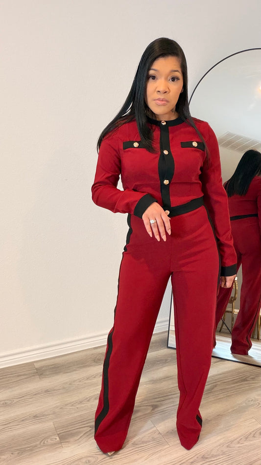 Woman wearing a tailored two-piece set with contrast trim and wide-leg pants.