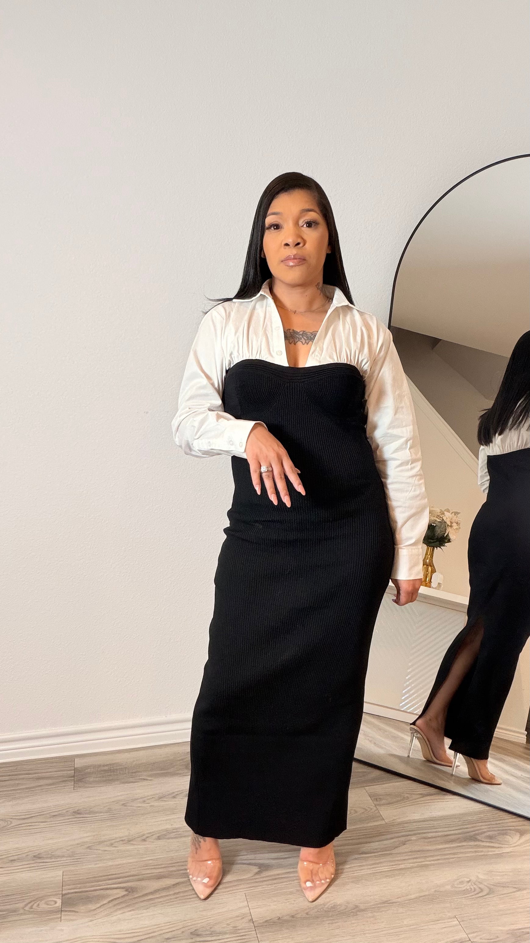 Woman wearing a minimalist column dress with a structured, body-skimming silhouette .