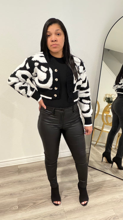 Woman wearing high-rise black sculpted tights pants with a fitted silhouette and smooth finish.