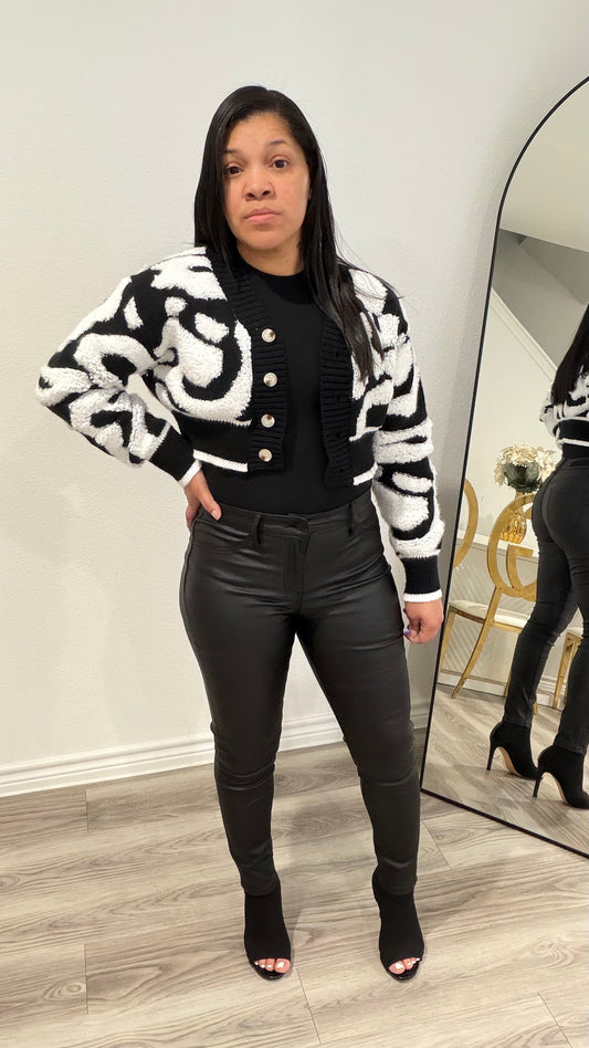 Woman wearing high-rise black sculpted tights pants with a fitted silhouette and smooth finish.