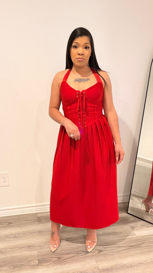 Woman wearing a structured corset dress with a fitted bodice and flowing skirt